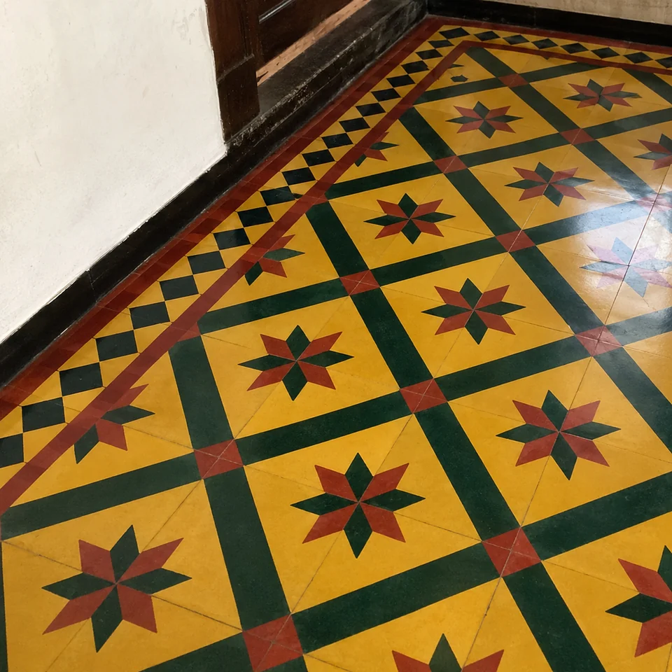 Detail of an Athangudi star pattern in yellow, green and red